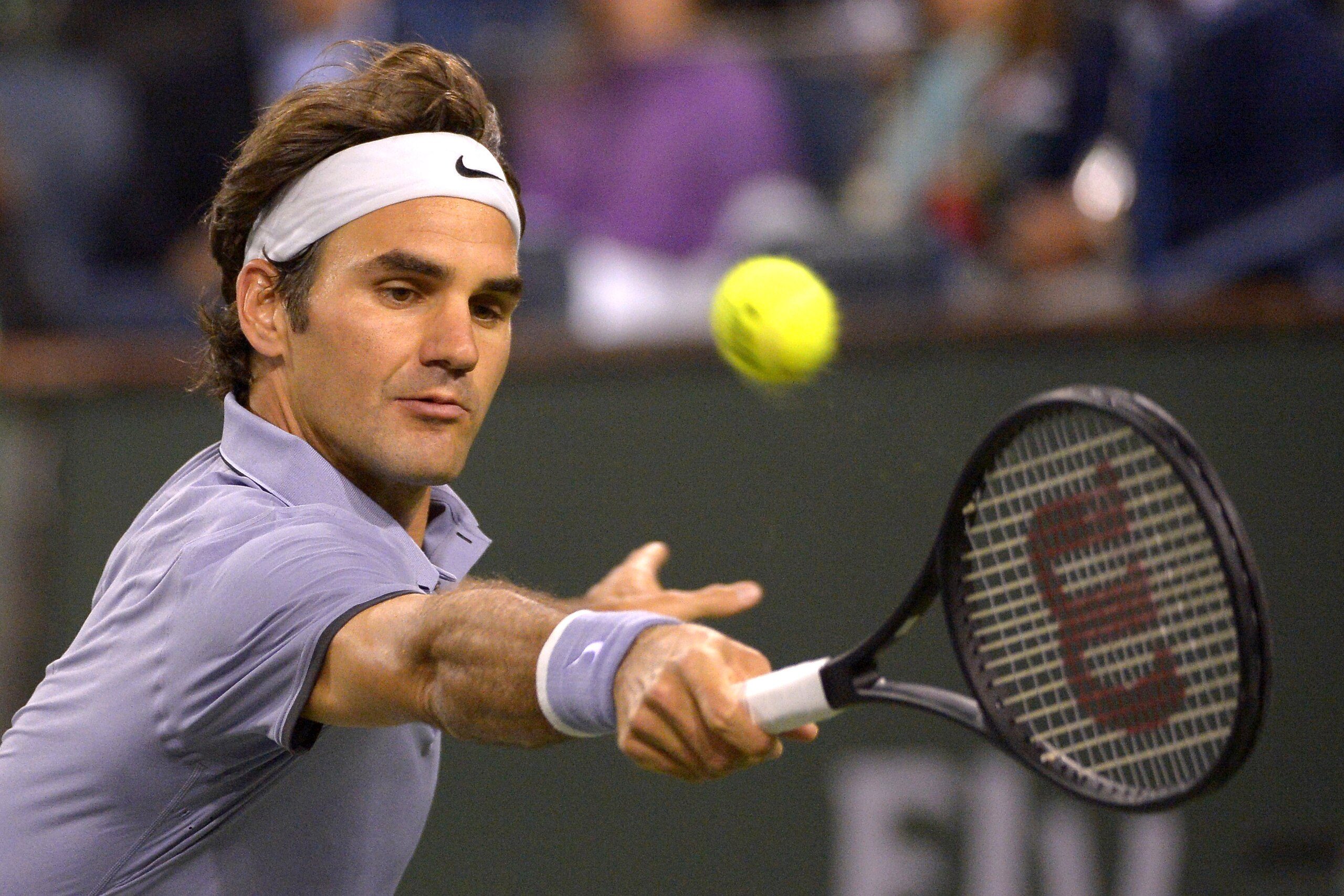 Roger Federer, of Switzerland, reaches for a backhand return to Kevin Anderson, of South Africa, during the quarterfinals of the BNP Paribas Open tennis tournament, Thursday, March 13, 2014, in Indian Wells, Calif. (AP Photo/Mark J. Terrill)
