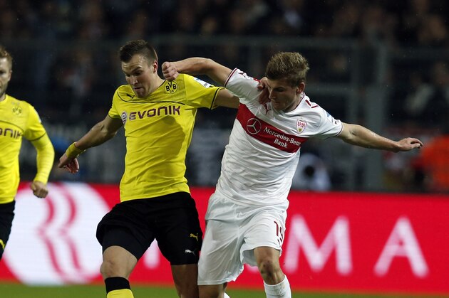 Dortmund's Kevin Grosskreutz, center, and Stuttgart's Timo Werner challenge for the ball during the German first division Bundesliga soccer match between  BvB Borussia Dortmund and VfB Stuttgart  in Dortmund, Germany, Friday, Nov. 1, 2013. (AP Photo/Frank Augstein)