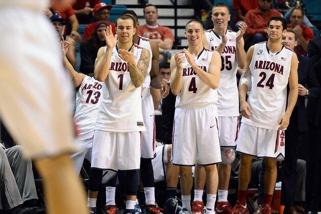 LAS VEGAS, NV - MARCH 13:  (L-R) Gabe York #1, T.J. McConnell #4, Kaleb Tarczewski #35 and Elliott Pitts #24 of the Arizona Wildcats applaud as they watch teammates play in the final moments of their quarterfinal game of the Pac-12 Basketball Tournament against the Utah Utes at the MGM Grand Garden Arena on March 13, 2014 in Las Vegas, Nevada. Arizona won 71-39.  (Photo by Ethan Miller/Getty Images)