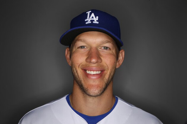 Los Angeles Dodgers pitcher Clayton Kershaw tosses a baseball during photo day Feb. 20, 2014  in Glendale, Ariz. (AP Photo/Paul Sancya)