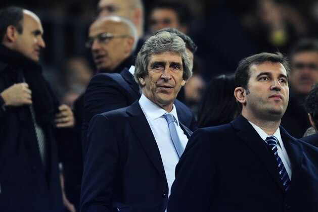 Manchester City's manager Manuel Pellegrini, center, on the stands, waits for the start of the Champions League, round of 16, second leg, soccer match between FC Barcelona and Manchester City at the Camp Nou Stadium in Barcelona, Spain, Wednesday March 12, 2014. (AP Photo/Manu Fernandez)