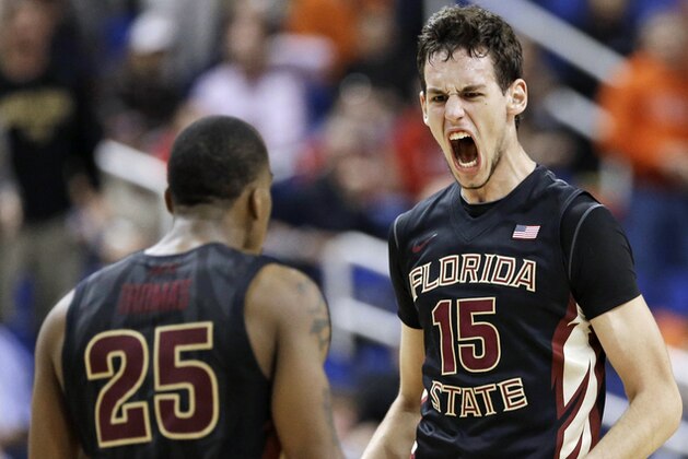 Florida State's Boris Bojanovsky (15) celebrates with Aaron Thomas (25) after dunking for the winning basket against Maryland in a second round NCAA college basketball game at the Atlantic Coast Conference tournament in Greensboro, N.C., Thursday, March 13, 2014. Florida State won 67-65. (AP Photo/Gerry Broome)