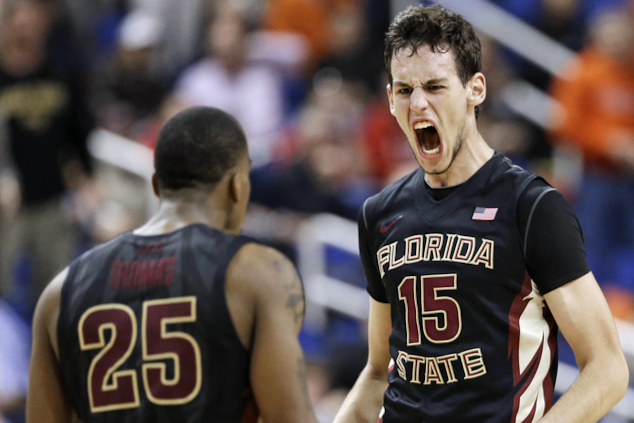 Florida State's Boris Bojanovsky (15) celebrates with Aaron Thomas (25) after dunking for the winning basket against Maryland in a second round NCAA college basketball game at the Atlantic Coast Conference tournament in Greensboro, N.C., Thursday, March 13, 2014. Florida State won 67-65. (AP Photo/Gerry Broome)