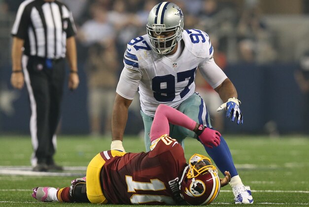 Oct 13, 2013; Arlington, TX, USA; Dallas Cowboys defensive tackle Jason Hatcher (97) sacks Washington Redskins quarterback Robert Griffin III in the second quarter at AT&T Stadium. Mandatory Credit: Matthew Emmons-USA TODAY Sports