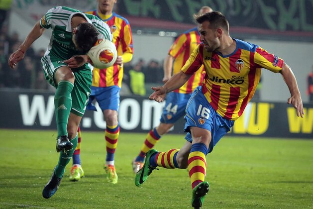 Ludogorets' Roman Bezjak, left, tries to control the ball next to Valencia's Paco Alcacer , right, during their Europa League round of 16 first leg soccer match at Vassil Levski stadium in Sofia, Thursday, March 13, 2014. (AP Photo/Valentina Petrova)