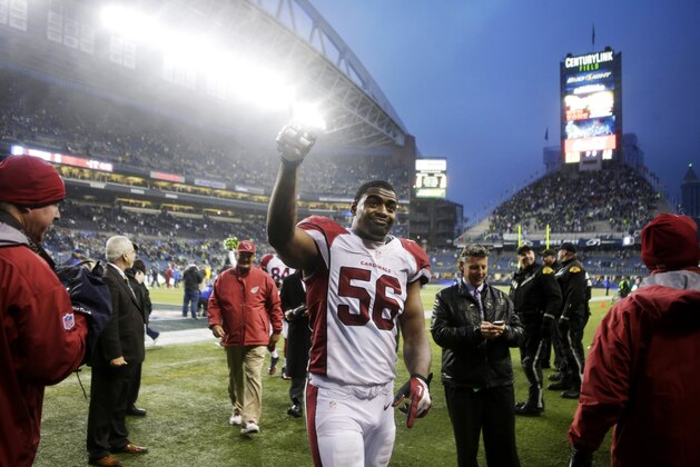 Arizona Cardinals inside linebacker Karlos Dansby (56) walks off CenturyLink Field after the Cardinals beat the Seattle Seahawks 17-10 in an NFL football game, Sunday, Dec. 22, 2013, in Seattle. (AP Photo/Stephen Brashear)