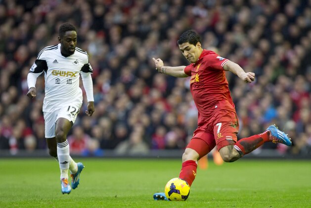 Liverpool's Luis Suarez keeps the ball from Swansea City's Nathan Dyer during their English Premier League soccer match at Anfield Stadium, Liverpool, England, Sunday Feb. 23, 2014. (AP Photo/Jon Super)