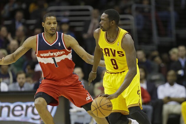 Cleveland Cavaliers' Luol Deng (9), from Sudan, goes against Washington Wizards' Trevor Ariza (1) in an NBA basketball game Sunday, Feb. 23, 2014, in Cleveland. (AP Photo/Mark Duncan)