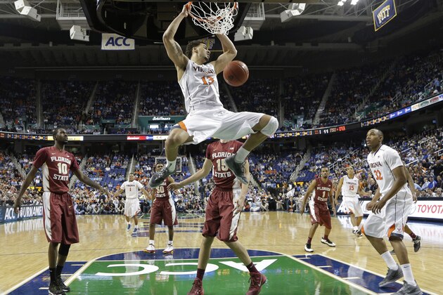 Virginia's Anthony Gill (13) dunks against Florida State during the first half of a quarterfinal NCAA college basketball game at the Atlantic Coast Conference tournament in Greensboro, N.C., Friday, March 14, 2014. (AP Photo/Gerry Broome)