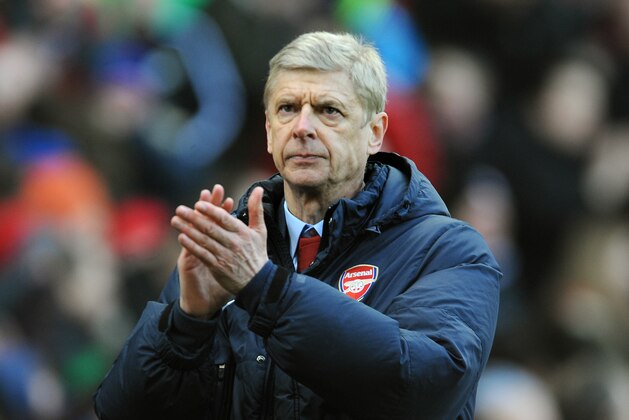 Arsenal manager Arsene Wenger applauds fans after the English Premier League soccer match between Stoke City and Arsenal at Britannia Stadium in Stoke On Trent, England, Saturday, March 1, 2014. (AP Photo/Rui Vieira)