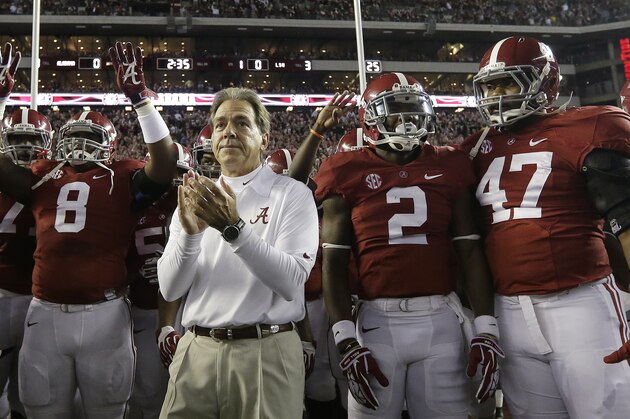 Alabama head coach Nick Saban prepares to lead his team onto the field in the first half of an NCAA college football game against LSU in Tuscaloosa, Ala., Saturday, Nov. 9, 2013.  (AP Photo/Dave Martin)