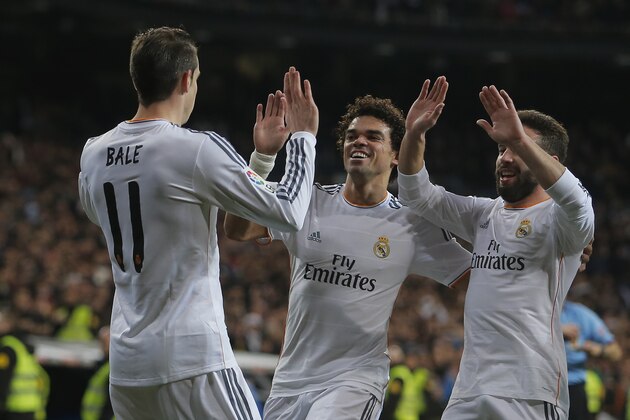 Real Madrid's Gareth Bale from Great Britain, left, celebrates his goal with Real Madrid's Pepe, centre, and Real Madrid's Daniel Carvajal, right during a Spanish La Liga soccer match between Real Madrid and Villarreal at the Bernabeu stadium stadium in Madrid, Spain, Saturday, Feb. 8, 2014. (AP Photo/Andres Kudacki)
