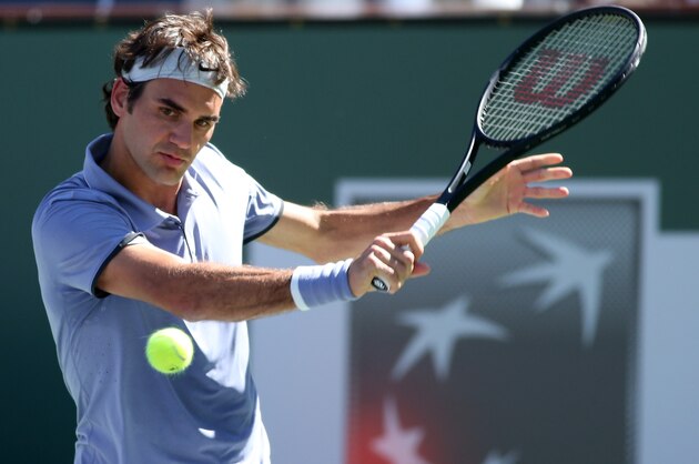 INDIAN WELLS, CA - MARCH 10:  Roger Federer of Switzerland hits a return to Dmitry Tursunov of Russia during the BNP Paribas Open at Indian Wells Tennis Garden on March 9, 2014 in Indian Wells, California.  Federer won 7-6 (7), 7-6 (2).  (Photo by Stephen Dunn/Getty Images).  (Photo by Stephen Dunn/Getty Images)