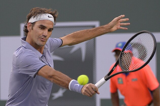 Roger Federer, of Switzerland, returns a shot against Tommy Haas, of Germany, during a match at the BNP Paribas Open tennis tournament, Wednesday, March 12, 2014, in Indian Wells, Calif. (AP Photo/Mark J. Terrill)