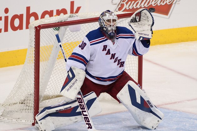 WINNIPEG, MB - MARCH 14:  Henrik Lundqvist #30 of the New York Rangers catches the puck in third-period action in an NHL game against the Winnipeg Jets at the MTS Centre on March 14, 2014 in Winnipeg, Manitoba, Canada. (Photo by Marianne Helm/Getty Images)