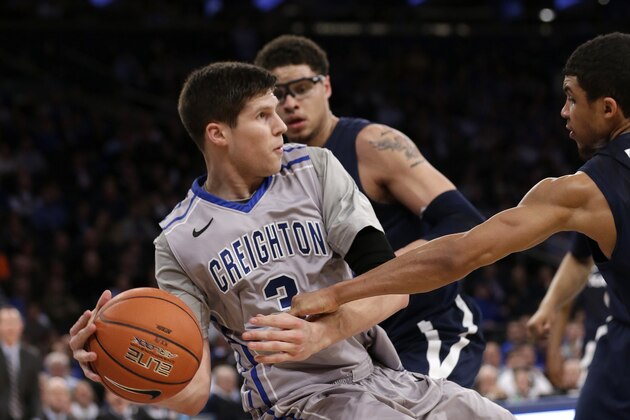 Creighton's Doug McDermott fights for control of the ball with Xavier's Dee Davis during the first half of an NCAA college basketball game in the semifinals of the Big East Conference men's tournament Friday, March 14, 2014, at Madison Square Garden in New York. (AP Photo/Frank Franklin II)