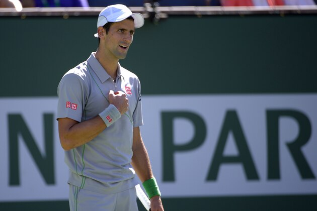 Novak Djokovic, of Serbia, celebrates after winning a quarterfinal match 6-1, 6-3, against Julien Benneteau, of France at the BNP Paribas Open tennis tournament, Friday, March 14, 2014, in Indian Wells, Calif. (AP Photo/Mark J. Terrill)