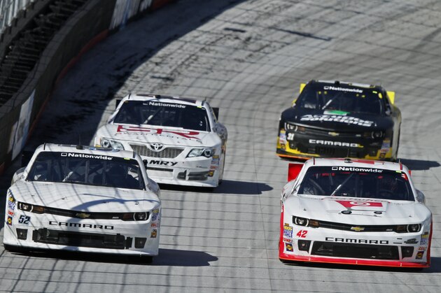 Joey Gase (52) and JJ Yeley (42) lead Kelly Admiraal, back left, and Dylan Kwasniewski (31) during practice for the NASCAR Nationwide series auto race at Bristol Motor Speedway on Friday, March 14, 2014, in Bristol, Tenn. (AP Photo/Wade Payne)