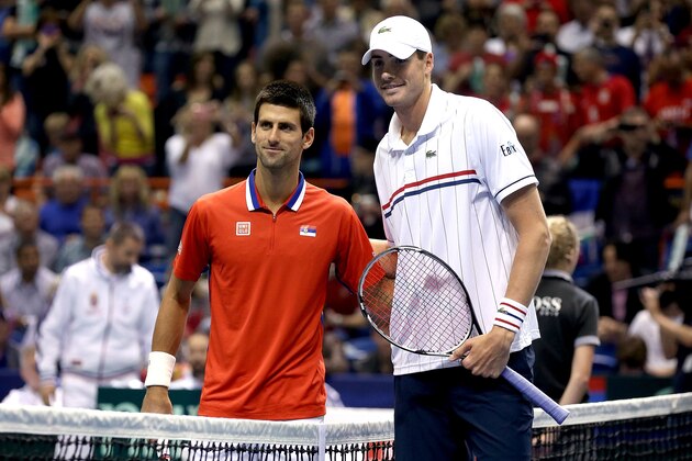 BOISE, ID - APRIL 05:  Novak Djokovic of Serbia and John Isner pose at the net during the first match of the Davis Cup tie between the United States and Serbia at Taco Bell Arena on April 5, 2013 in Boise, Idaho.  (Photo by Matthew Stockman/Getty Images)