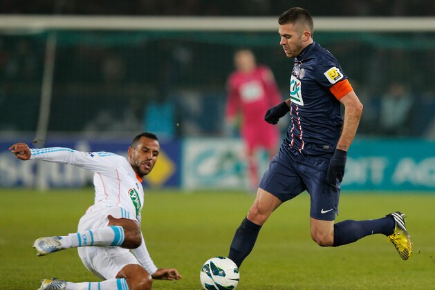 PARIS, FRANCE - FEBRUARY 27:  Jeremy Menez of PSG is tackled by Alaixys Romao of Marseille during the French Cup match between Paris Saint-Germain FC and Marseille Olympic OM at Parc des Princes on February 27, 2013 in Paris, France.  (Photo by Dean Mouhtaropoulos/Getty Images)