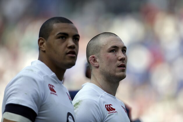 England's Mike Brown, right, and teammate Luther Burrell walk on the pitch at the end of the Six Nations international rugby union match between Italy and England at Rome's Olympic stadium, Saturday, March 15, 2014. (AP Photo/Gregorio Borgia)