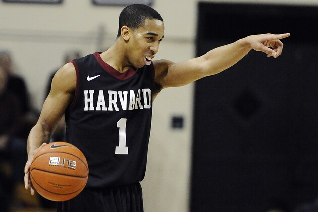Harvard's Siyani Chambers, points and smiles at his team as he dribbles in the final seconds of an NCAA college basketball game against Yale, Friday, March 7, 2014, in New Haven, Conn. Harvard won 70-58. (AP Photo/Jessica Hill)