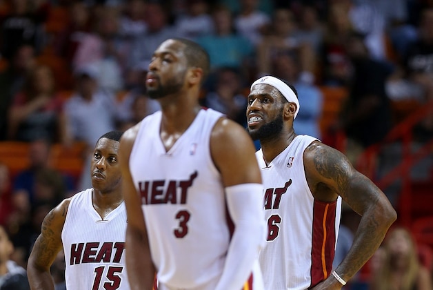 MIAMI, FL - MARCH 14: LeBron James #6, Dwyane Wade #3 and Mario Chalmers #15 of the Miami Heat look on during a game against the Denver Nuggets at American Airlines Arena on March 14, 2014 in Miami, Florida. NOTE TO USER: User expressly acknowledges and agrees that, by downloading and/or using this photograph, user is consenting to the terms and conditions of the Getty Images License Agreement. Mandatory copyright notice:  (Photo by Mike Ehrmann/Getty Images)