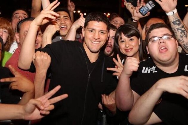 Mar 16, 2013; Montreal, Quebec, CAN;  Nick Diaz (blue) lands a punch on Georges St.Pierre (red) during their Welterweight title bout at UFC 158 at the Bell Centre. Mandatory Credit: Eric Bolte-USA TODAY Sports