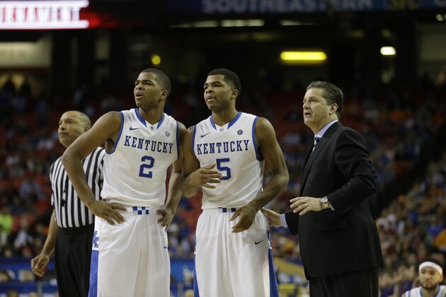 Kentucky head coach John Calipari speaks to players Aaron Harrison (2) and Andrew Harrison (5) during the second half of an NCAA college basketball game against LSU in the quarterfinal round of the Southeastern Conference men's tournament, Friday, March 14, 2014, in Atlanta. (AP Photo/Steve Helber)