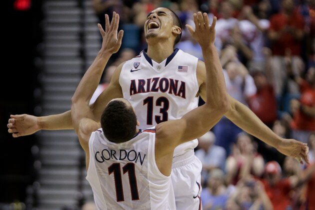 Arizona's Nick Johnson (13) reacts with Aaron Gordon after hitting a 3-point basket against Colorado during the first half of an NCAA college basketball game in the semifinals of the Pac-12 Conference on Friday, March 14, 2014, in Las Vegas. (AP Photo/Julie Jacobson)