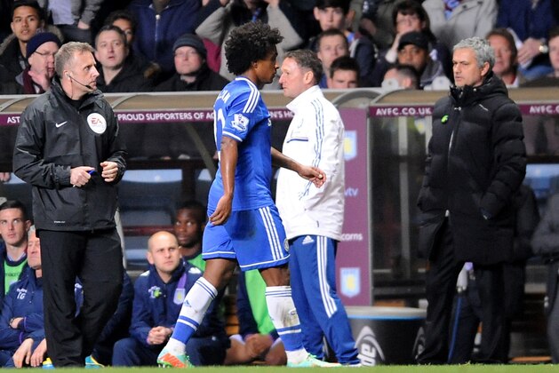 Chelsea's Willian, center, leaves the pitch after being sent off during the English Premier League soccer match between Aston Villa and Chelsea at Villa Park, Birmingham, England, Saturday, March 15, 2014.  (AP Photo/Rui Vieira)