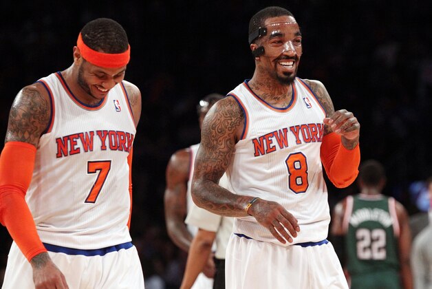 Mar 15, 2014; New York, NY, USA; New York Knicks forward Carmelo Anthony (7) and guard J.R. Smith (8) react during the game against the Milwaukee Bucks at Madison Square Garden. Mandatory Credit: Noah K. Murray-USA TODAY Sports