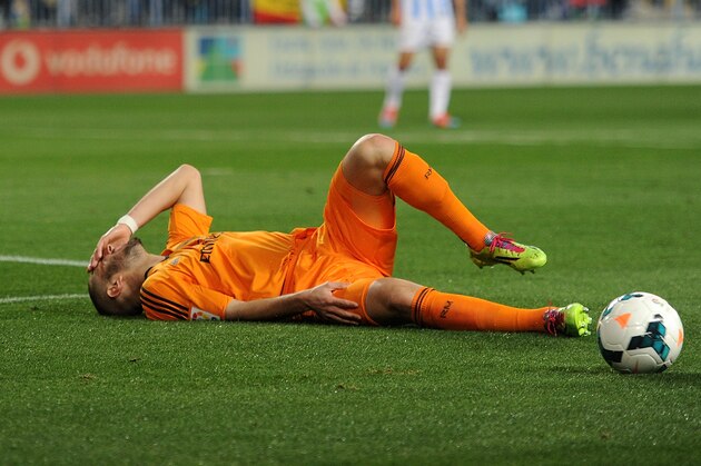 MALAGA, SPAIN - MARCH 15:  Karim Benzema of Real Madrid FC lies injured during the La Liga match between Malaga and Real Madrid at La Rosaleda Stadium on March 15, 2014 in Malaga, Spain.  (Photo by Denis Doyle/Getty Images)