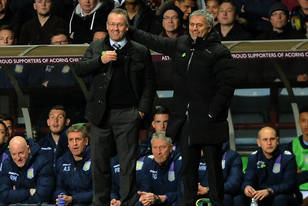 Chelsea manager Jose Mourinho, right, and Aston Villa manager Paul Lambert speak during the English Premier League soccer match between Aston Villa and Chelsea at Villa Park, Birmingham, England, Saturday, March 15, 2014.  (AP Photo/Rui Vieira)