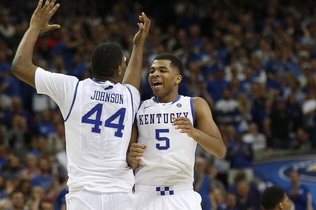 Kentucky guard Andrew Harrison (5) and Kentucky center Dakari Johnson (44) celebrate in the closing moments of the second half of an NCAA college basketball game against Georgia in the semifinal round of the Southeastern Conference men's tournament, Saturday, March 15, 2014, in Atlanta. Kentucky won 70-58. (AP Photo/John Bazemore)