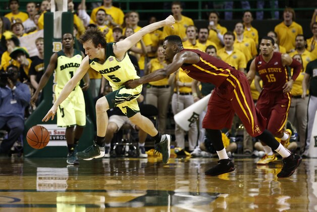 Mar 4, 2014; Waco, TX, USA; Baylor Bears guard Brady Heslip (5) and Iowa State Cyclones forward Melvin Ejim (3) chase a loose ball during the second half of a mens basketball game at The Ferrell Center. Baylor won 74-61. Mandatory Credit: Jim Cowsert-USA TODAY Sports
