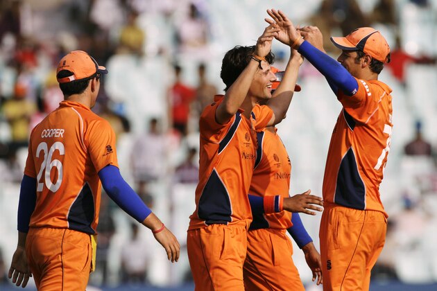 Netherlands' Pieter Seelaar, center, celebrates with fellow team members after the dismissal of Ireland's Paul Stirling during a Cricket World Cup match between Ireland and Netherlands in Calcutta, India, Friday, March 18, 2011. (AP Photo/Bikas Das)