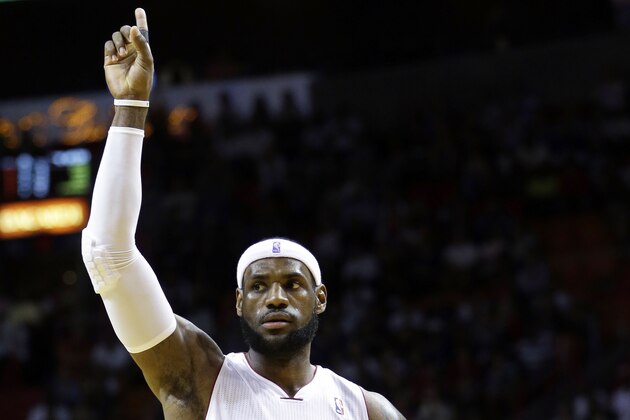 Miami Heat forward LeBron James (6) celebrates after scoring against the Denver Nuggets during the first half of an NBA basketball game in Miami, Friday, March 14, 2014. (AP Photo/Alan Diaz)