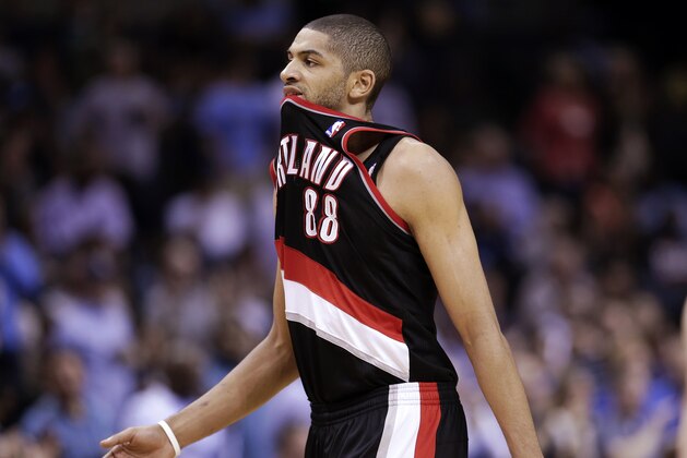 Portland Trail Blazers forward Nicolas Batum, of France, walks to the bench during a timeout in the first half of an NBA basketball game against the Memphis Grizzlies on Tuesday, March 11, 2014, in Memphis, Tenn. The Grizzlies won 109-99. (AP Photo/Mark Humphrey)