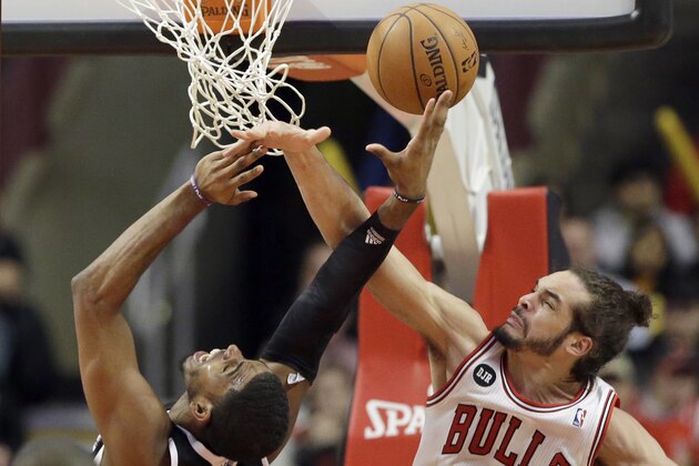 Chicago Bulls center Joakim Noah, right, blocks a shot by Sacramento Kings forward Jason Thompson during the second half of an NBA basketball game in Chicago on Saturday, March 15, 2014. The Bulls won 94-87. (AP Photo/Nam Y. Huh)