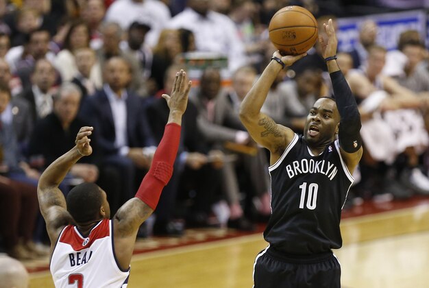 Mar 15, 2014; Washington, DC, USA; Brooklyn Nets guard Marcus Thornton (10) shoots the ball over Washington Wizards guard Bradley Beal (3) in the third quarter at Verizon Center. The Wizards won 101-94. Mandatory Credit: Geoff Burke-USA TODAY Sports