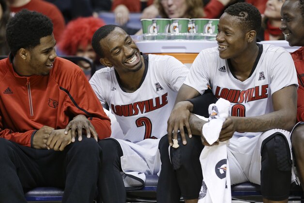 Louisville guard Russ Smith (2) laughs on the bench with Terry Rozier (0) during the final minutes of Louisville's 94-65 win over Houston in an NCAA college basketball game in the semifinals of the American Athletic Conference men's tournament Friday, March 14, 2014, in Memphis, Tenn. Smith led Louisville with 42 points. (AP Photo/Mark Humphrey)