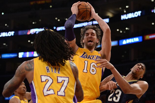 LOS ANGELES, CA - NOVEMBER 12:  Pau Gasol #16 of the Los Angeles Lakers grabs a rebound in front of teammate Jordan Hill #27 and Anthony Davis #23 of the New Orleans Pelicans during the first half at Staples Center on November 12, 2013 in Los Angeles, California.  NOTE TO USER: User expressly acknowledges and agrees that, by downloading and or using this Photograph, user is consenting to the terms and condition of the Getty Images License Agreement.  (Photo by Harry How/Getty Images)
