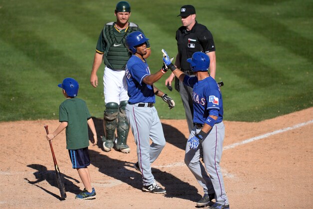 Mar 15, 2014; Phoenix, AZ, USA; Texas Rangers outfielder Nick Williams (46) celebrates a home run against the Oakland Athletics at Phoenix Municipal Stadium. Mandatory Credit: Joe Camporeale-USA TODAY Sports