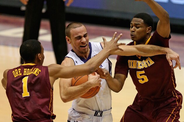 EVANSTON, IL - FEBRUARY 16:  Tre Demps #14 of the Northwestern Wildcats tries to drive between Andre Hollins #1 and Daquein McNeil #5 of the Minnesota Golden Gophers at Welsh-Ryan Arena on February 16, 2014 in Evanston, Illinois.  (Photo by Jonathan Daniel/Getty Images)