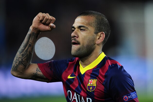 Barcelona's Daniel Alves celebrates at the end of their Champions League, round of 16, second leg, soccer match between FC Barcelona and Manchester City at the Camp Nou Stadium in Barcelona, Spain, Wednesday March 12, 2014. Alves scored the second goal in Barcelona's 2-1 win. (AP Photo/Manu Fernandez)