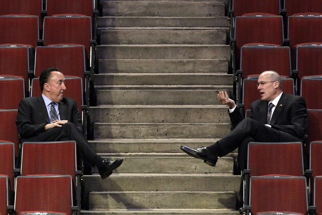 Chicago Bulls general manager Gar Foreman, left, and John Paxson, executive vice president of basketball operations, talk before an NBA basketball game between the Bulls and Houston Rockets, Monday, April 2, 2012, in Chicago. (AP Photo/Charles Rex Arbogast)