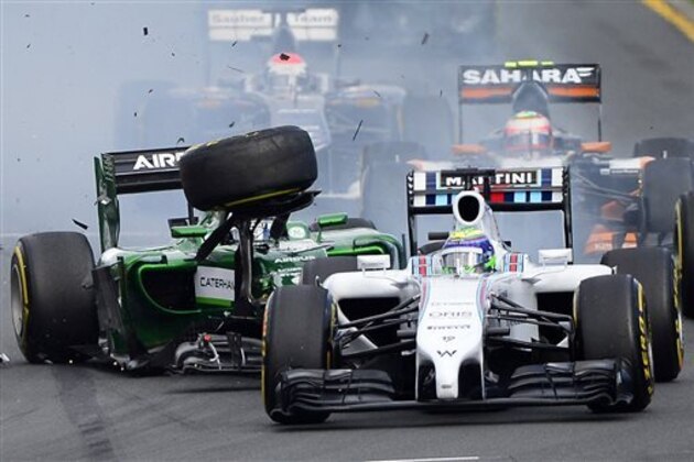 Caterham driver Kamui Kobayashi of Japan, left, collides with Williams driver Felipe Massa of Brazil at the start of the Australian Formula One Grand Prix at Albert Park in Melbourne, Australia, Sunday, March 16, 2014. Massa and Kobayashi walked away uninjured from the accident. (AP Photo/Ross Land)
