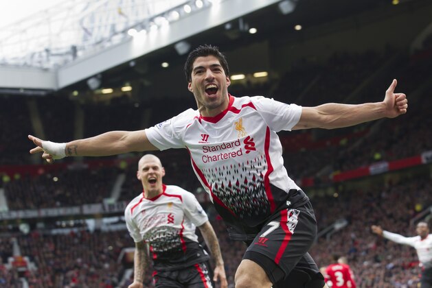 Liverpool's Luis Suarez celebrates after scoring against Manchester United, during their English Premier League soccer match at Old Trafford Stadium, Manchester, England, Sunday, March 16, 2014. (AP Photo/Jon Super)