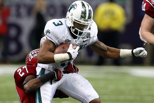 Dec 21, 2013; New Orleans, LA, USA; Tulane Green Wave wide receiver Ryan Grant (3) is tackled by Louisiana-Lafayette Ragin Cajuns safety T.J. Worthy (27) during the second half of the R&L Carriers New Orleans Bowl at the Mercedes-Benz Superdome. Louisiana-Lafayette defeated Tulane, 24-21. Mandatory Credit: Chuck Cook-USA TODAY Sports